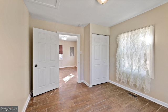 unfurnished bedroom with multiple windows, hardwood / wood-style floors, and a closet