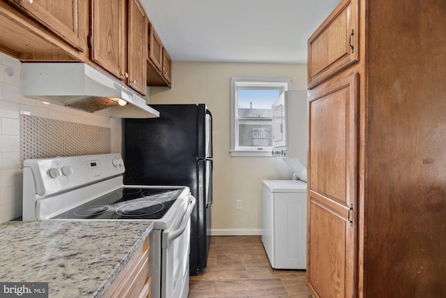 kitchen featuring light wood-type flooring, washer / dryer, decorative backsplash, white range with electric stovetop, and light stone countertops