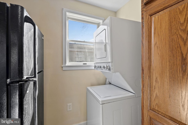 clothes washing area with stacked washer and clothes dryer