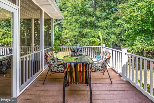 wooden deck with a sunroom