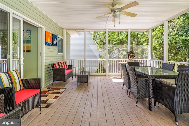 wooden terrace featuring ceiling fan and outdoor dining space