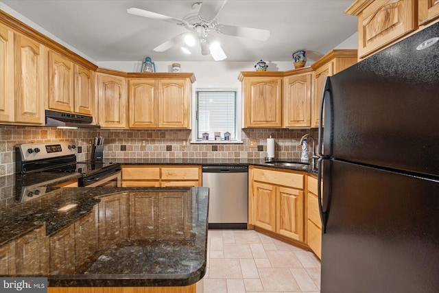 kitchen featuring a ceiling fan, a sink, decorative backsplash, under cabinet range hood, and appliances with stainless steel finishes