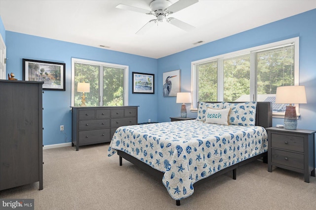 bedroom featuring visible vents, a ceiling fan, baseboards, and carpet floors