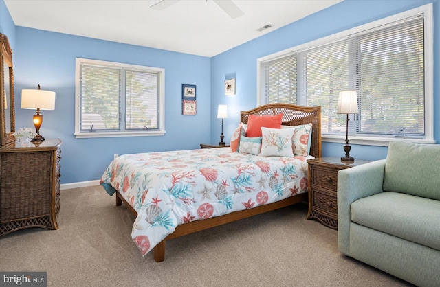 bedroom with visible vents, multiple windows, and carpet floors