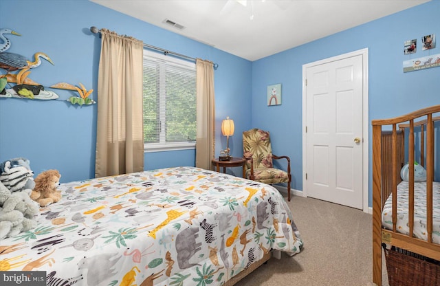 carpeted bedroom with visible vents, baseboards, and ceiling fan