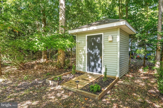 view of shed featuring fence