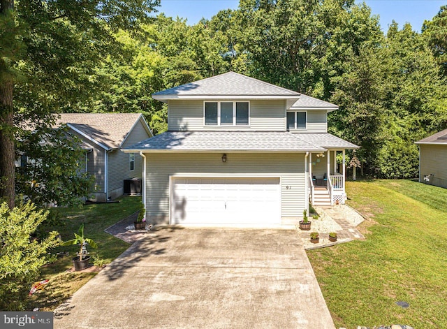 view of front of house featuring a garage, driveway, a front yard, and a shingled roof