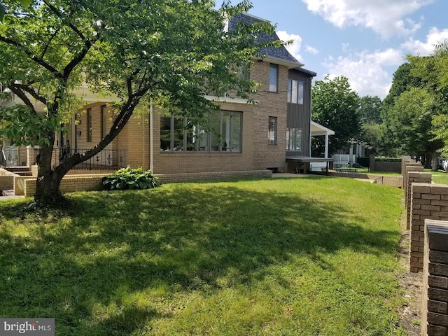 rear view of house with a yard