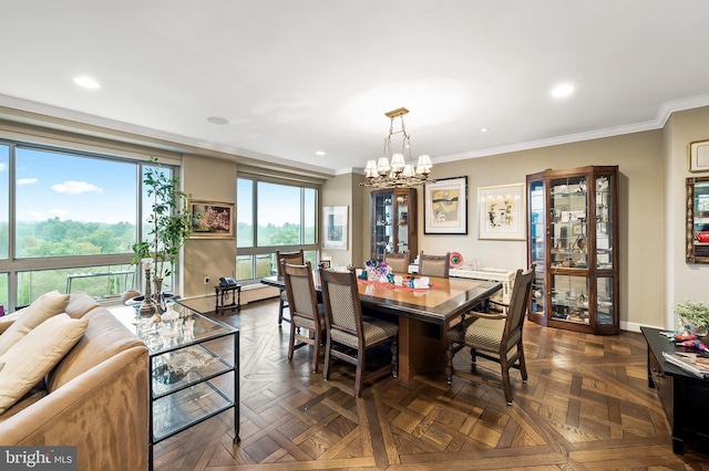 dining room featuring baseboards, ornamental molding, an inviting chandelier, and recessed lighting