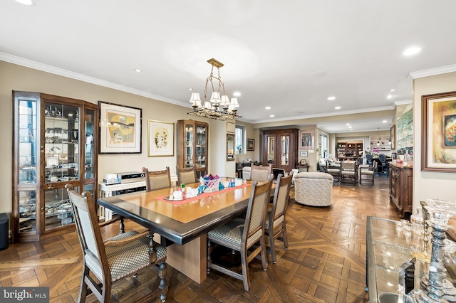 dining area featuring a notable chandelier, dark parquet flooring, and crown molding