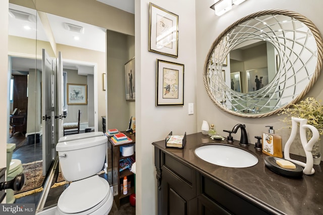 bathroom featuring vanity and toilet