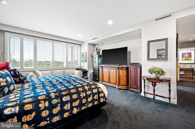 bedroom with dark carpet, visible vents, and recessed lighting