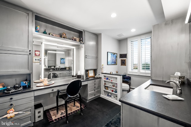 office area featuring built in desk and sink