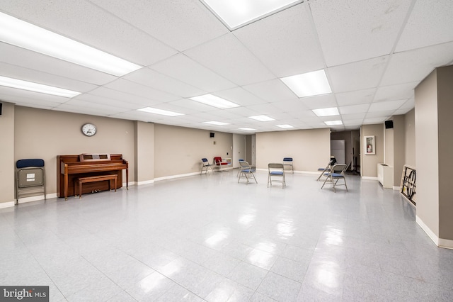 miscellaneous room featuring baseboards and a paneled ceiling