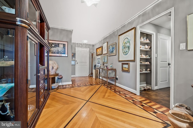interior space featuring crown molding and baseboards