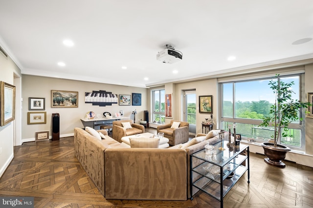 living room with dark parquet flooring and crown molding