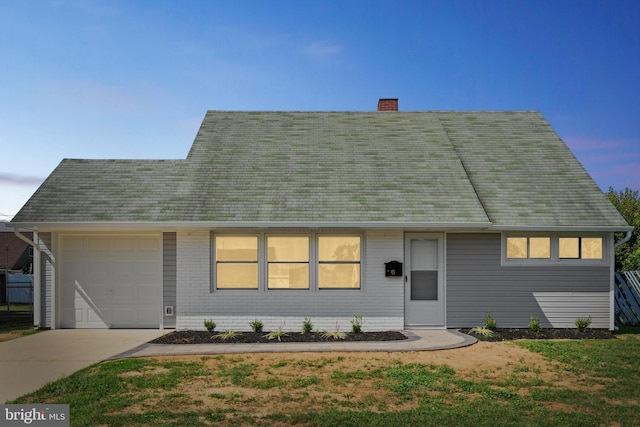 view of front of home with a lawn and a garage