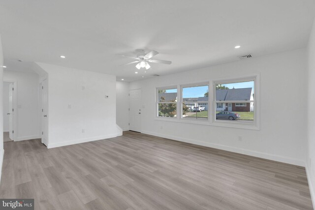 spare room with light hardwood / wood-style flooring and ceiling fan