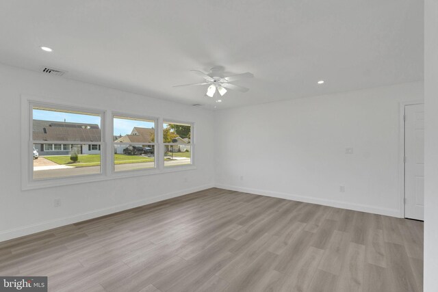 spare room featuring light wood-type flooring and ceiling fan