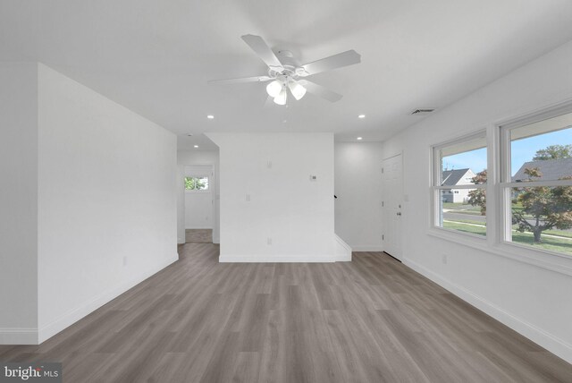 unfurnished room with ceiling fan, light hardwood / wood-style flooring, and a wealth of natural light