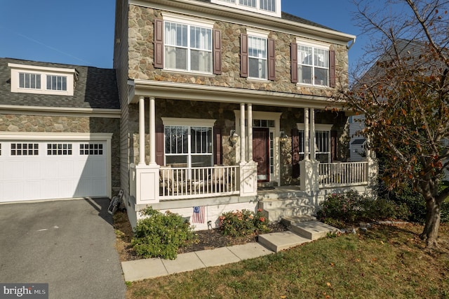 view of front of house with a porch and a garage