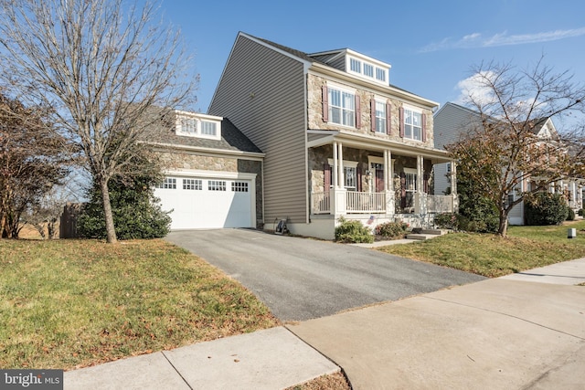 view of front of home featuring covered porch, a garage, and a front lawn