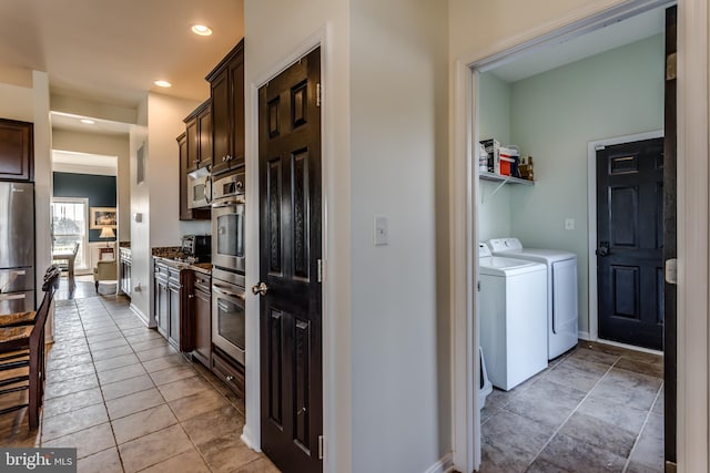 kitchen featuring independent washer and dryer, dark brown cabinetry, light tile patterned floors, and appliances with stainless steel finishes