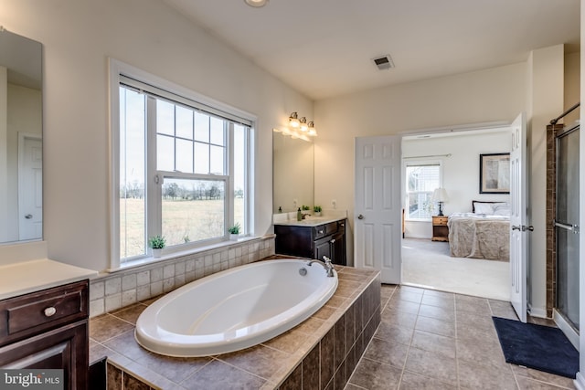 bathroom with vanity, tile patterned floors, and independent shower and bath