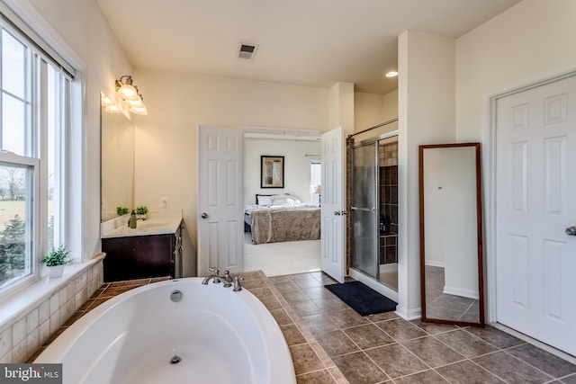 bathroom with tile patterned floors, vanity, and an enclosed shower