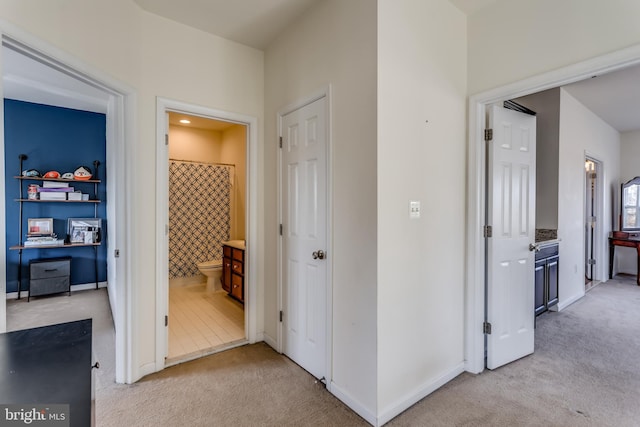 hallway with light colored carpet