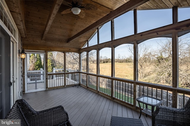 unfurnished sunroom with vaulted ceiling with beams, ceiling fan, and wooden ceiling