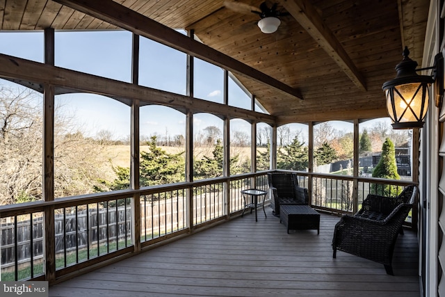 unfurnished sunroom featuring lofted ceiling with beams, plenty of natural light, and wooden ceiling