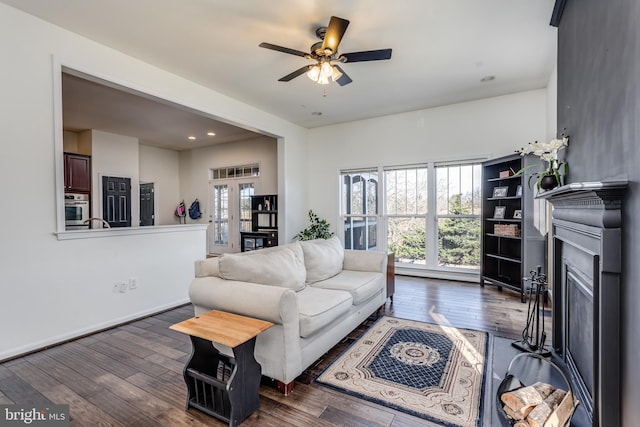 living room with dark hardwood / wood-style floors, ceiling fan, and french doors