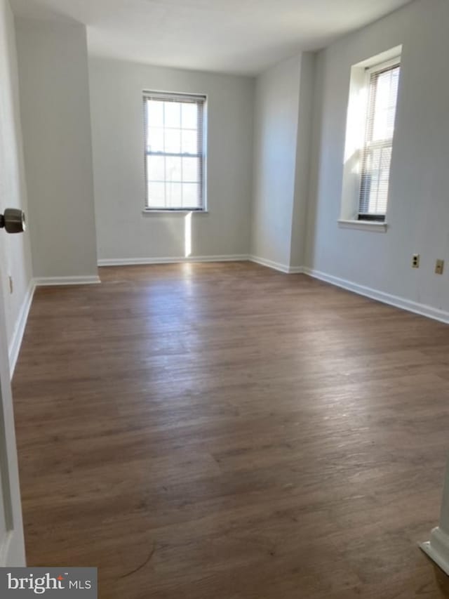 spare room with dark hardwood / wood-style flooring