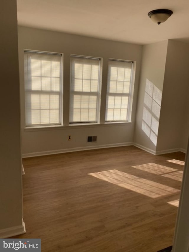 spare room with dark hardwood / wood-style flooring