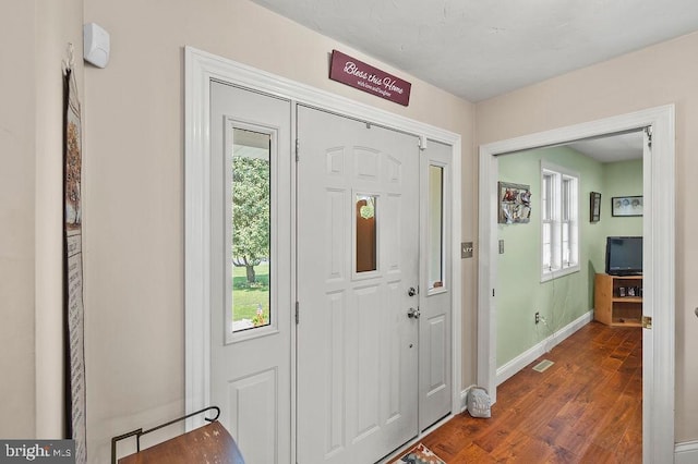 entryway with dark wood-type flooring