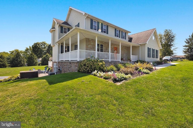 farmhouse-style home with a porch and a front lawn