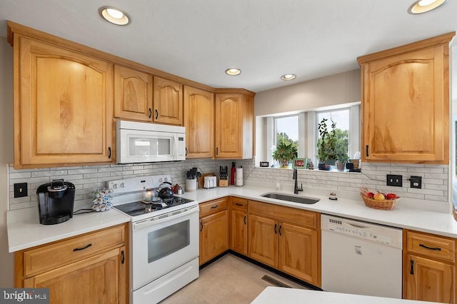 kitchen with light tile patterned flooring, white appliances, tasteful backsplash, and sink