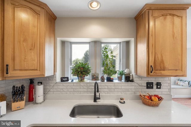 kitchen with sink, light brown cabinets, and tasteful backsplash