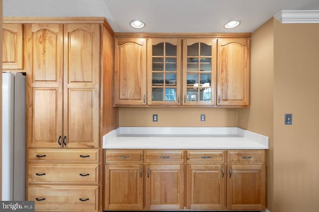 kitchen featuring crown molding and stainless steel fridge