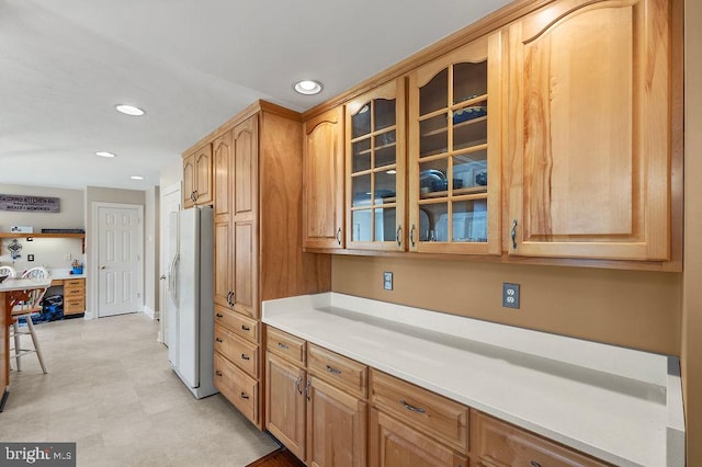 kitchen with white fridge with ice dispenser