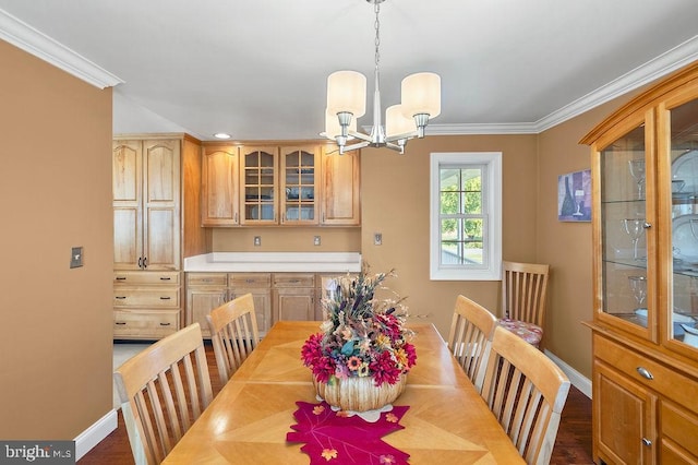 dining room featuring ornamental molding, wood-type flooring, and a chandelier