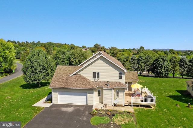 view of front of home with a wooden deck and a front lawn