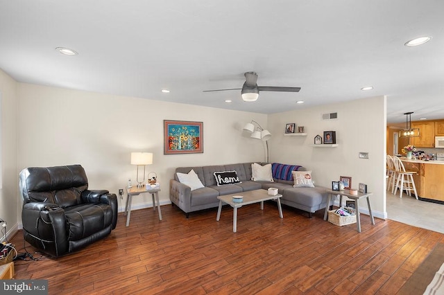 living room featuring ceiling fan and hardwood / wood-style flooring