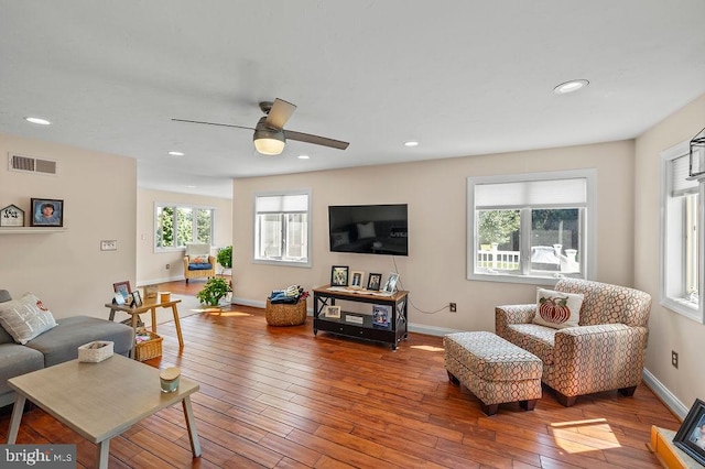 living room featuring ceiling fan, hardwood / wood-style flooring, and plenty of natural light