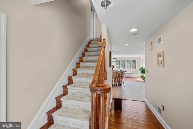 staircase featuring wood-type flooring