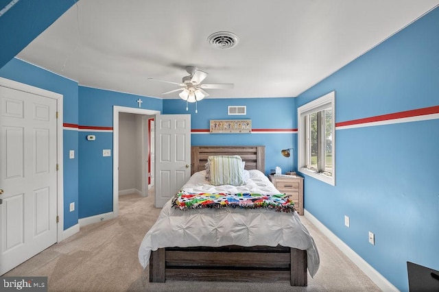 bedroom with light colored carpet and ceiling fan