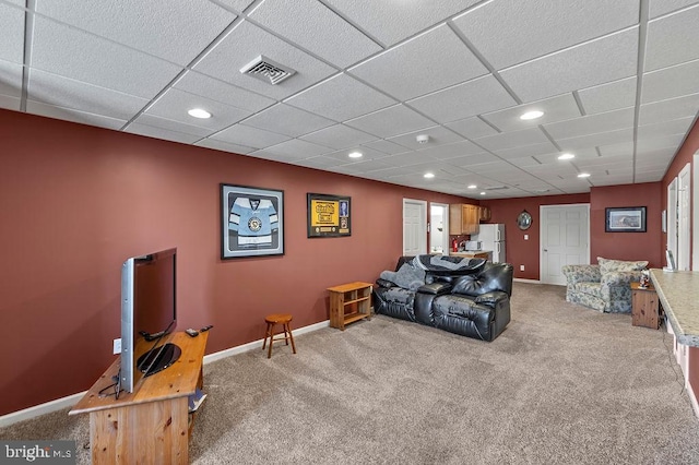 living room with light colored carpet and a paneled ceiling