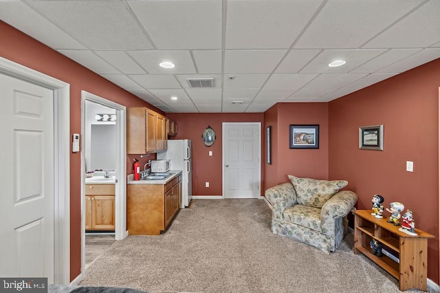 interior space with sink and a drop ceiling