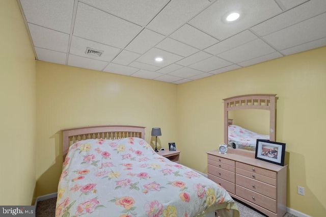 bedroom featuring carpet and a drop ceiling